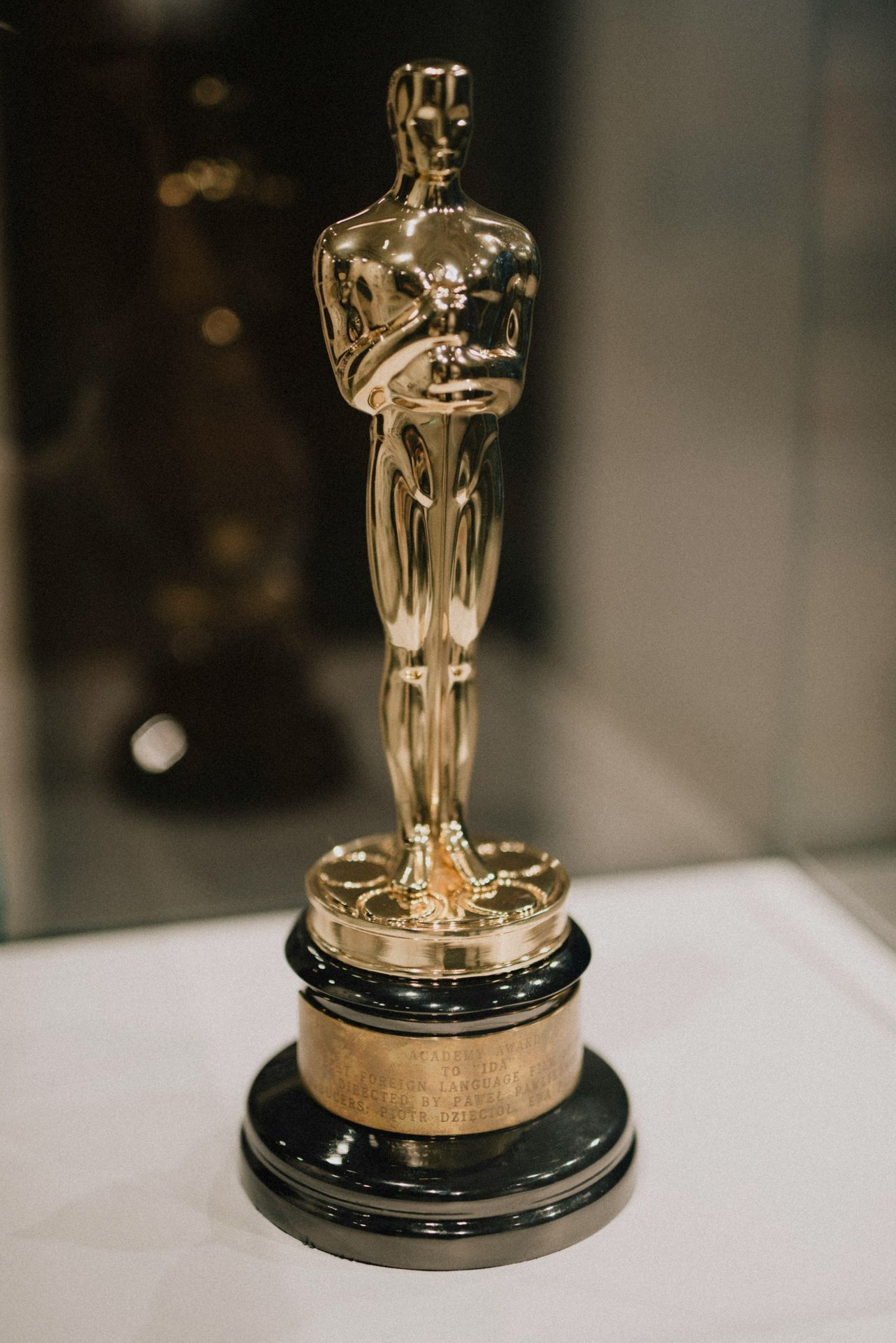 The image shows a golden oscar trophy.